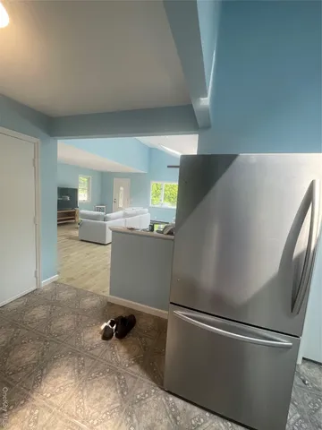 a room with wooden floor and electronic appliances