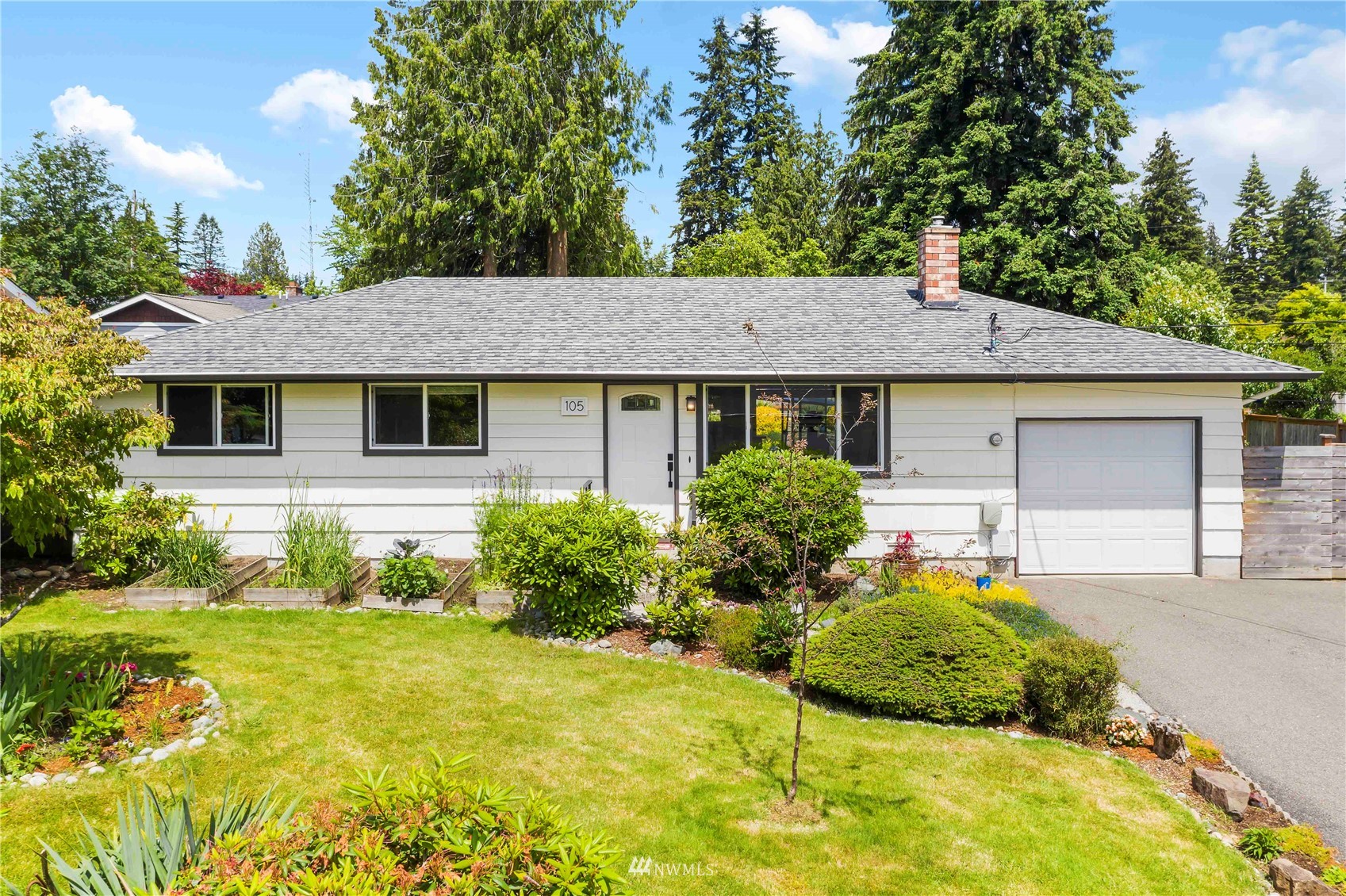105 234th Place Southwest Bothell, WA 98021 - Photo 1 of 27 a front view of a house with garden