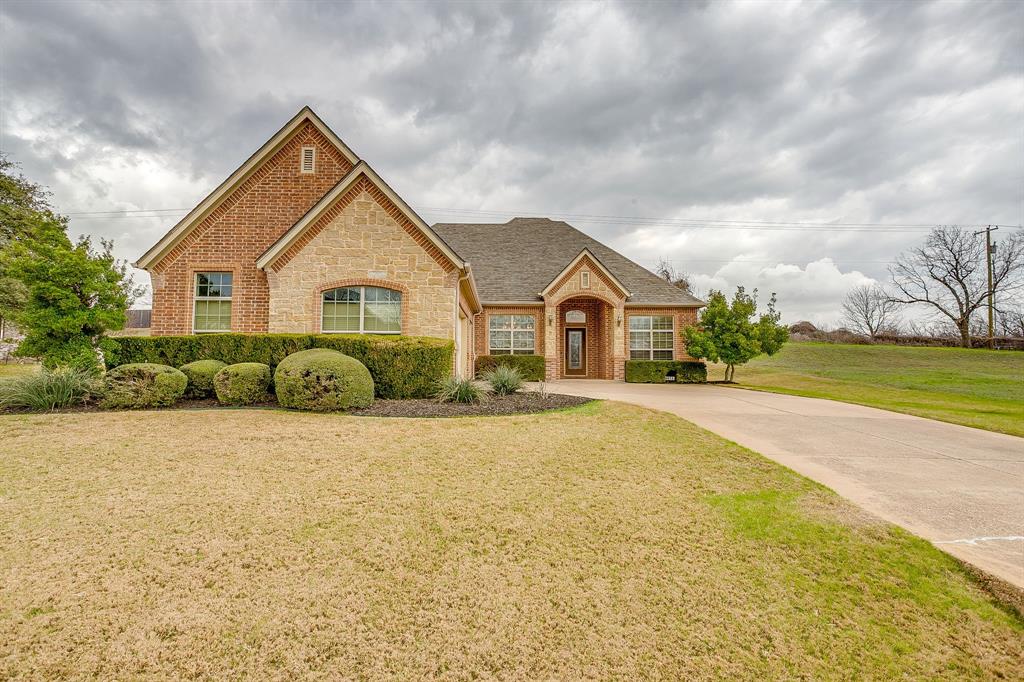 a view of a house with a yard and garage