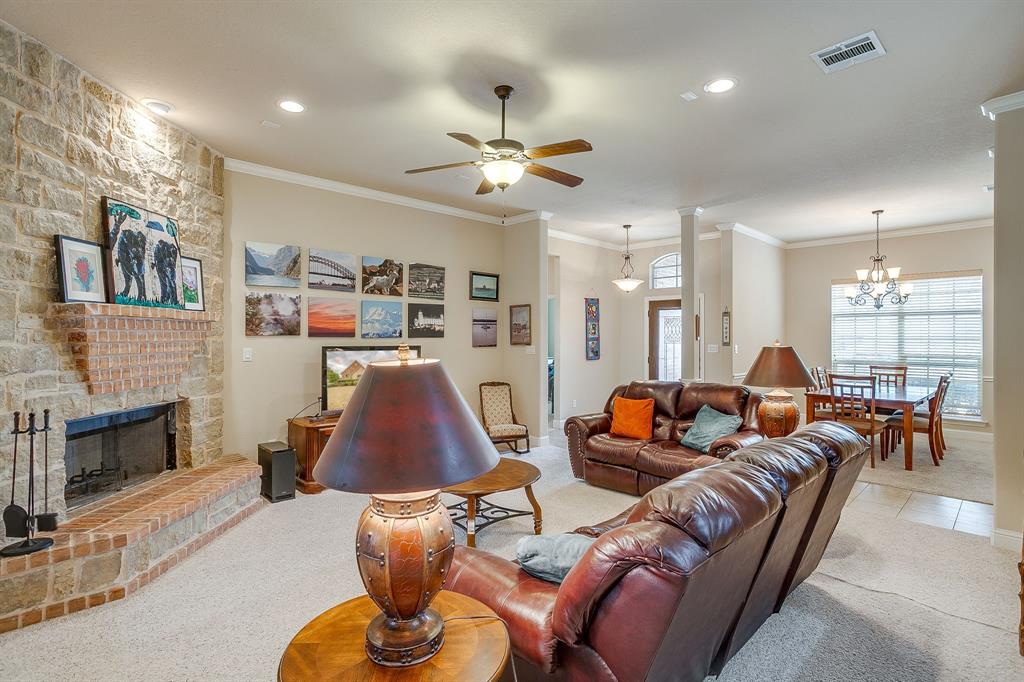 9815 Ravenswood Road Granbury, TX 76049 - Photo 11 of 40 a living room with furniture and a fireplace