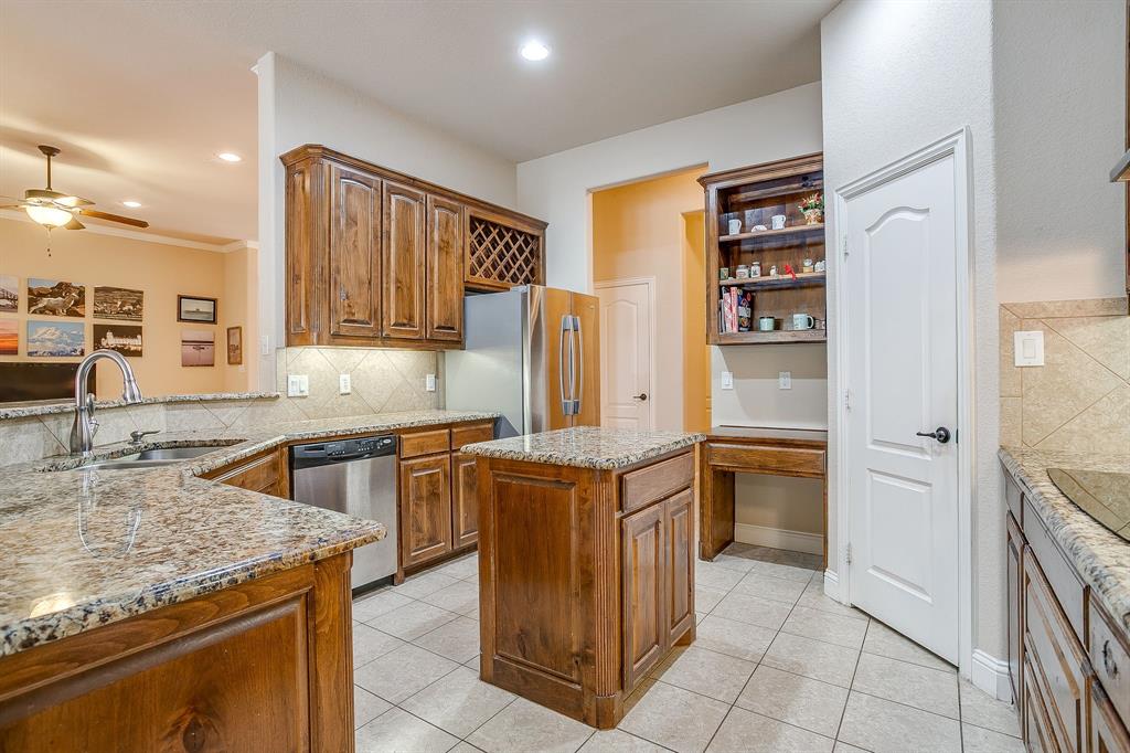 9815 Ravenswood Road Granbury, TX 76049 - Photo 14 of 40 a kitchen with stainless steel appliances granite countertop a refrigerator and a stove