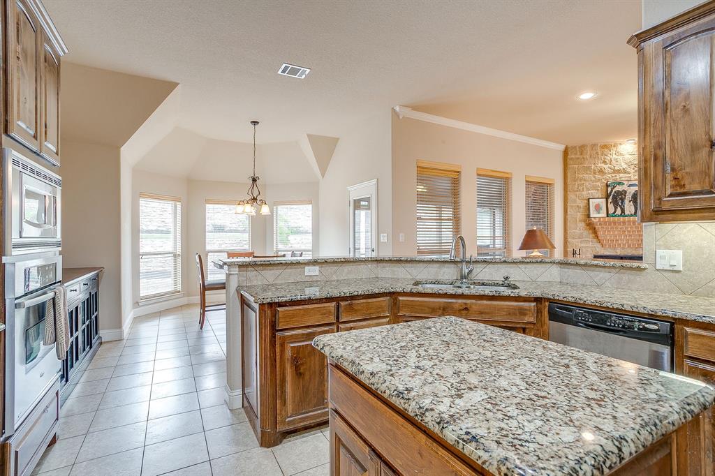 9815 Ravenswood Road Granbury, TX 76049 - Photo 15 of 40 a kitchen with a sink counter top space and appliances