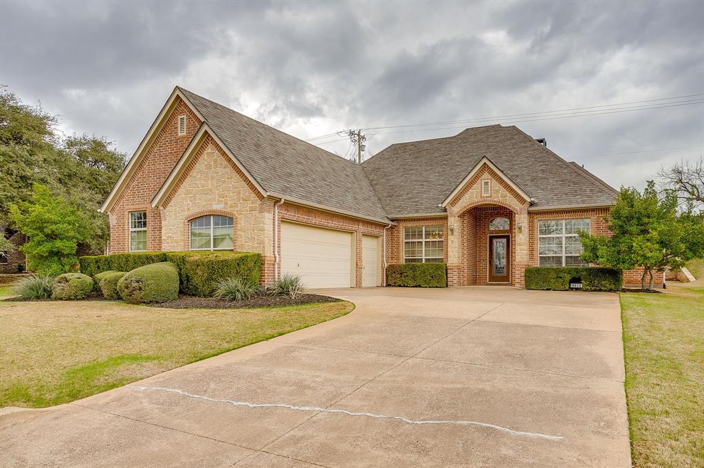 9815 Ravenswood Road Granbury, TX 76049 - Photo 2 of 40 a front view of a house with a yard and garage