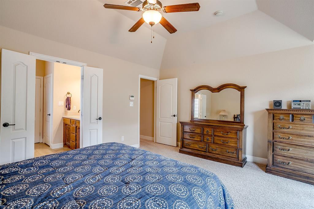 9815 Ravenswood Road Granbury, TX 76049 - Photo 21 of 40 a bedroom with a bed and a dresser