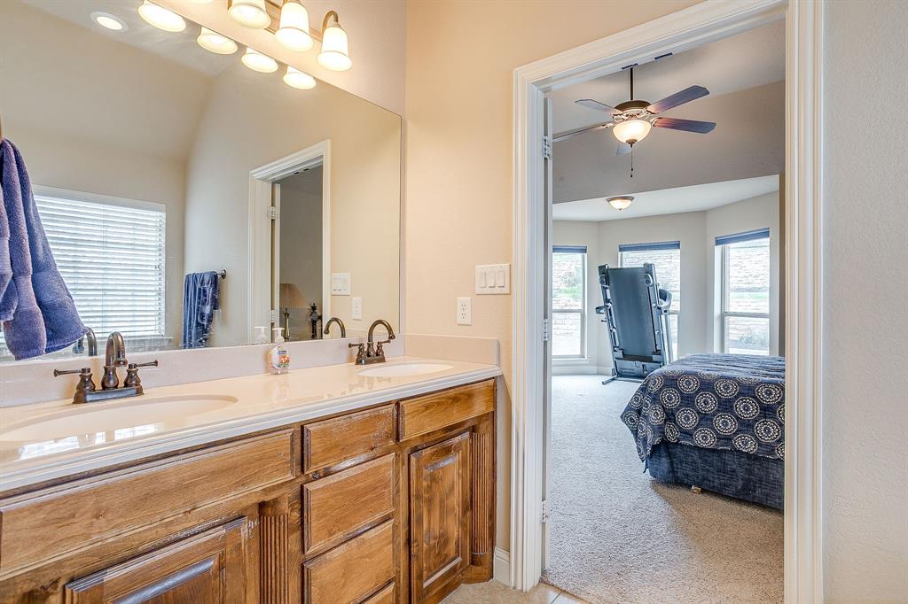 9815 Ravenswood Road Granbury, TX 76049 - Photo 24 of 40 a en suite bathroom with double sink and a mirror