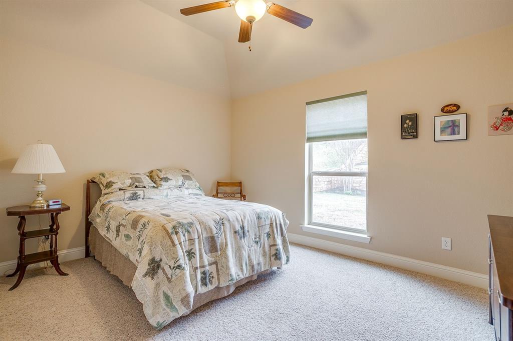 9815 Ravenswood Road Granbury, TX 76049 - Photo 32 of 40 a bedroom with a bed and a window