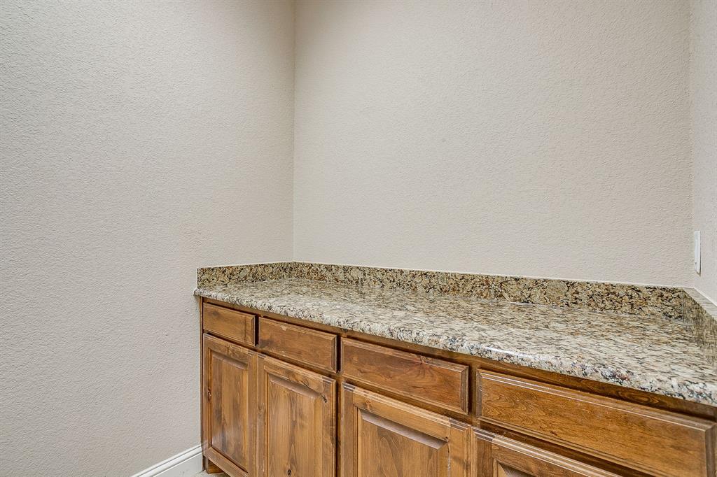 9815 Ravenswood Road Granbury, TX 76049 - Photo 35 of 40 a view of kitchen with granite countertop cabinets and sink