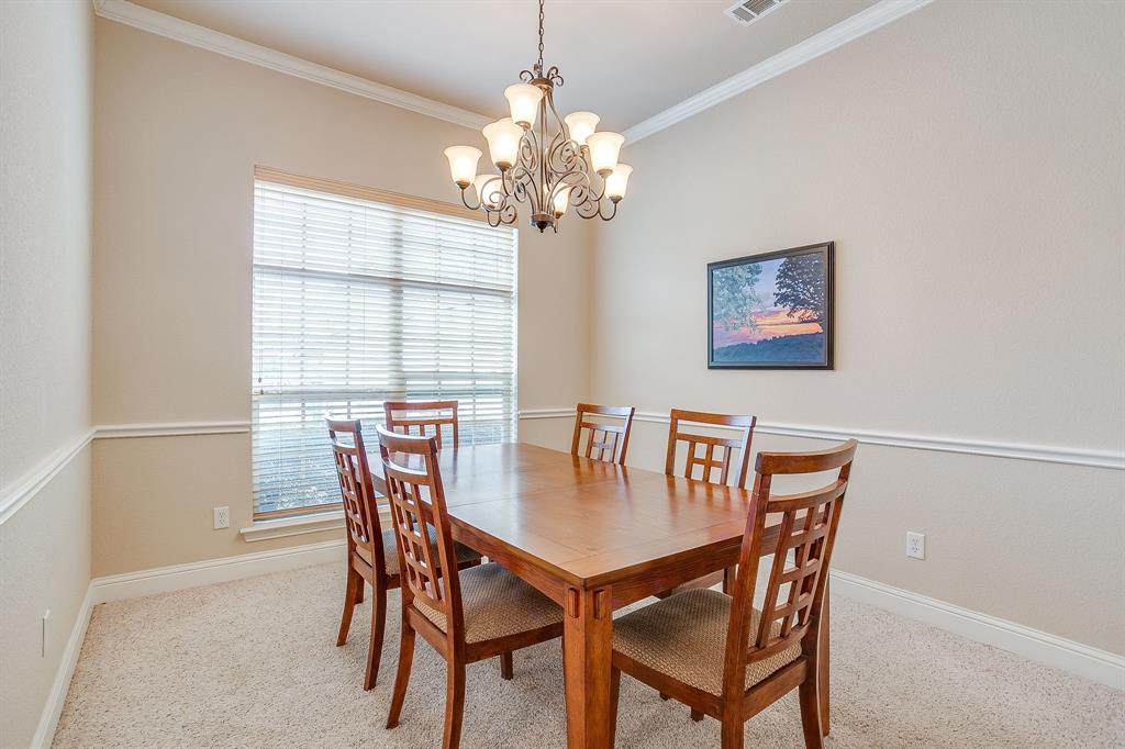 9815 Ravenswood Road Granbury, TX 76049 - Photo 5 of 40 a view of a dining room with furniture and chandelier