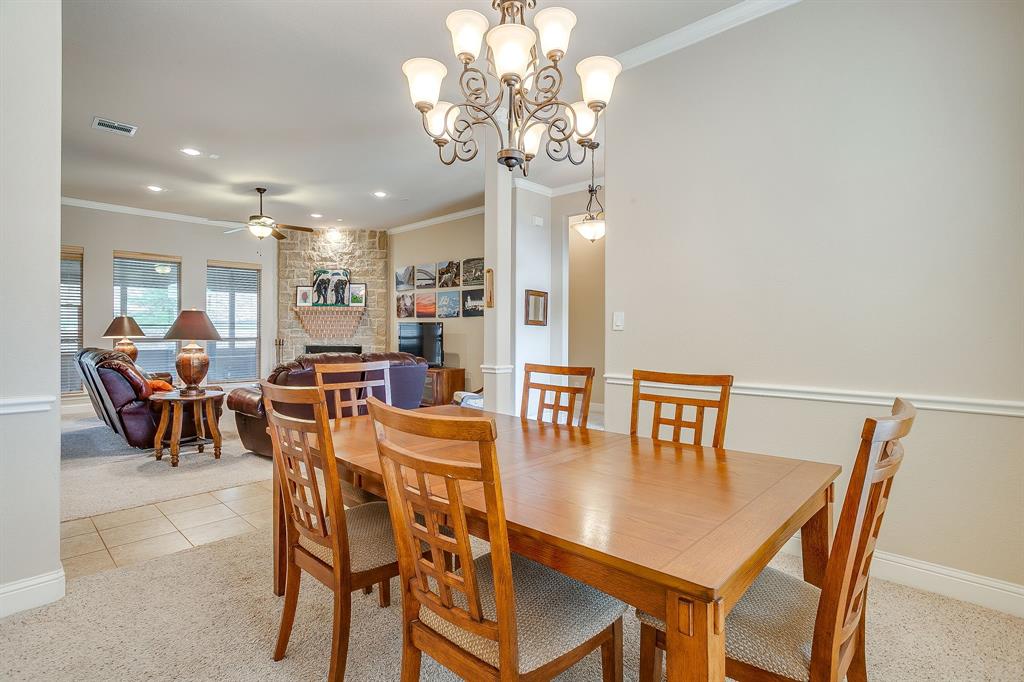 9815 Ravenswood Road Granbury, TX 76049 - Photo 7 of 40 a view of a dining room with furniture and chandelier