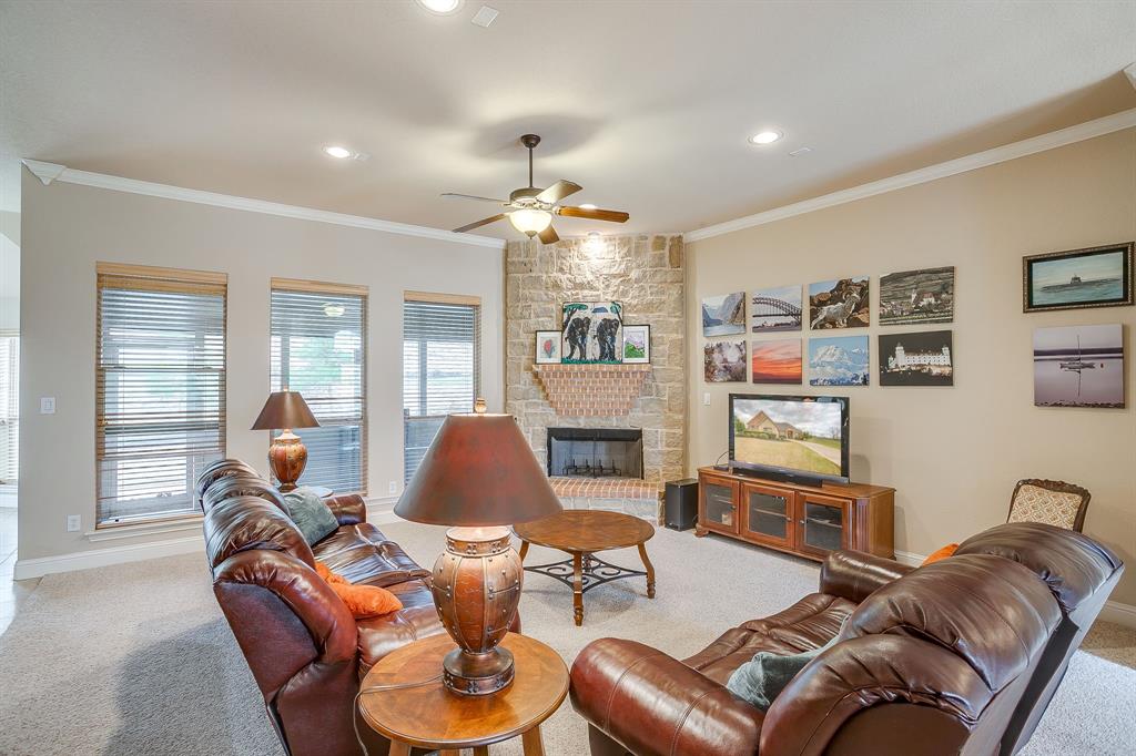 9815 Ravenswood Road Granbury, TX 76049 - Photo 8 of 40 a living room with furniture a chandelier and a wooden floor
