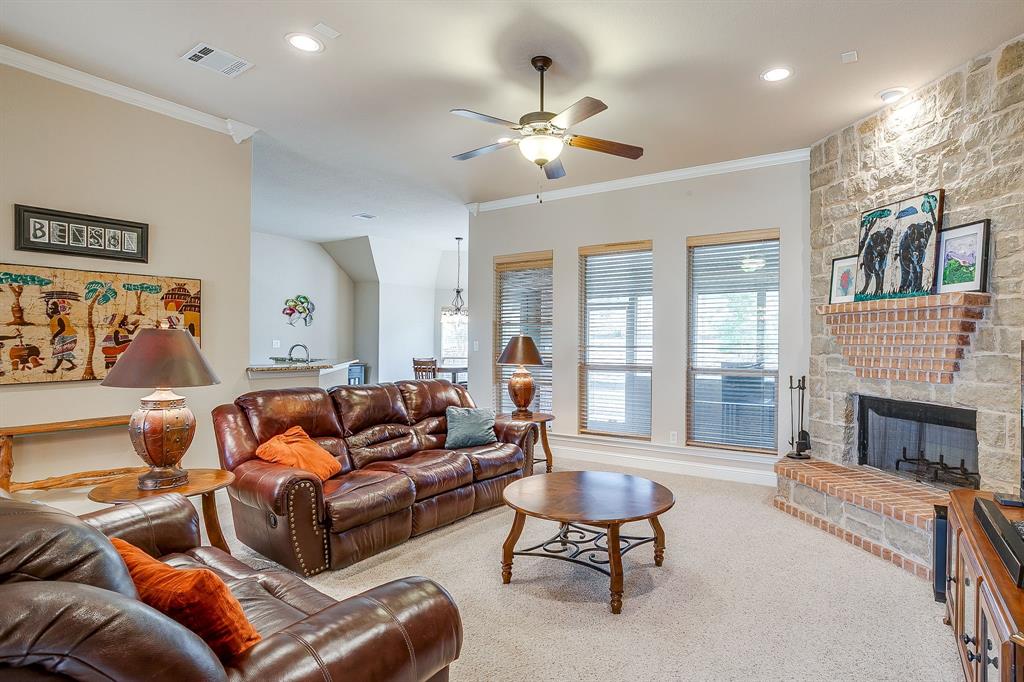 9815 Ravenswood Road Granbury, TX 76049 - Photo 9 of 40 a living room with furniture and a fireplace