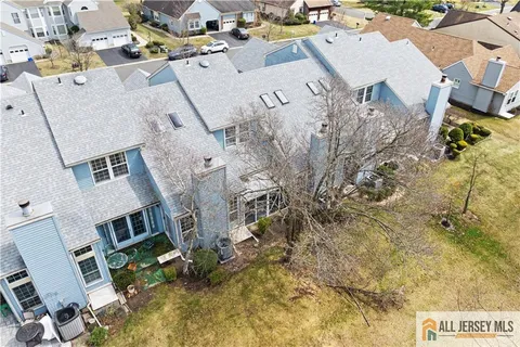 an aerial view of residential house with parking