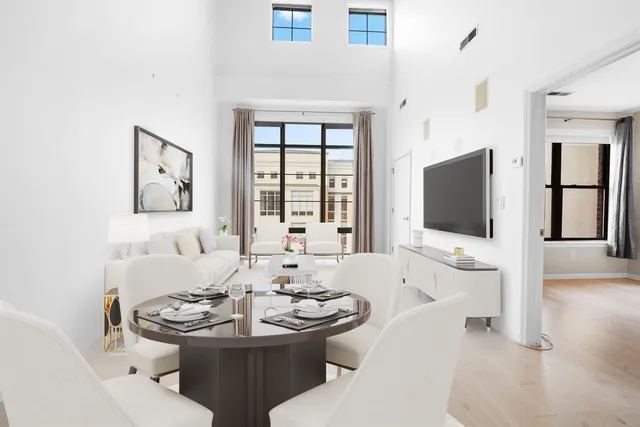 a living room with furniture a flat screen tv and a large window