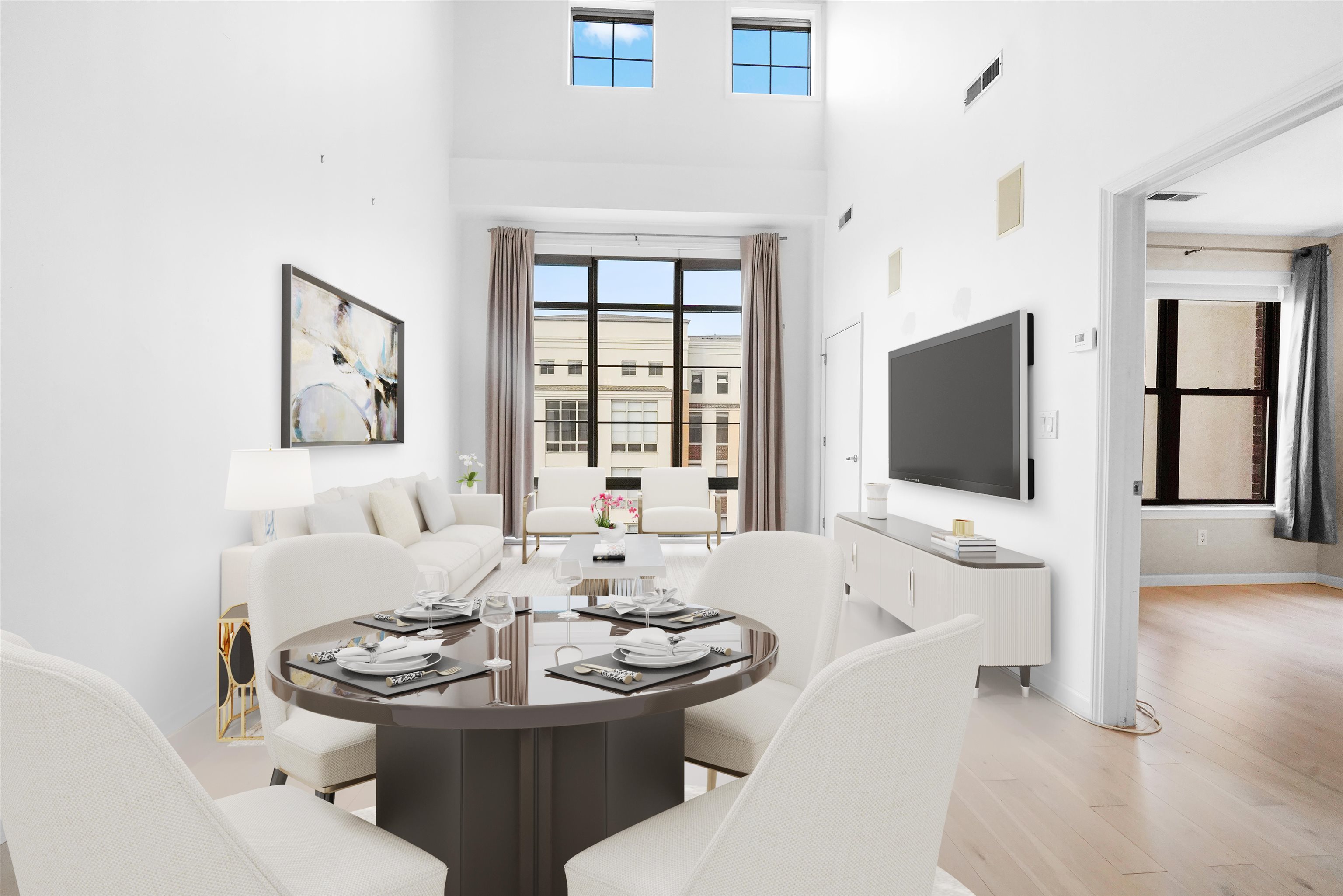 a living room with furniture a flat screen tv and a large window