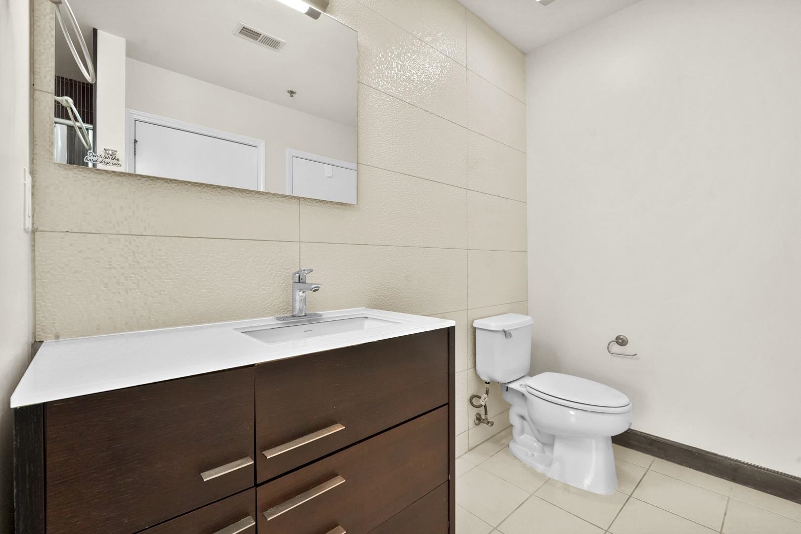 26 Ave At Port Imperial, Unit 440X West New York, NJ 07093 - Photo 11 of 36 a bathroom with a sink a toilet and a mirror