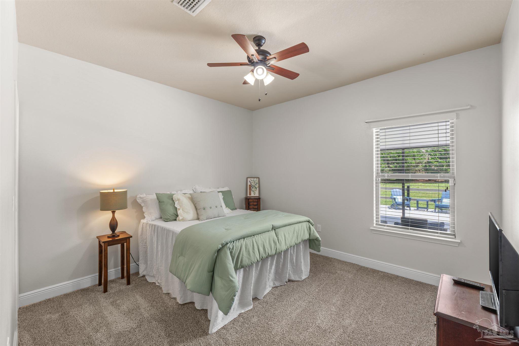 2698 Tulip Hill Road Pace, FL 32571 - Photo 44 of 65 a bedroom with a bed and window
