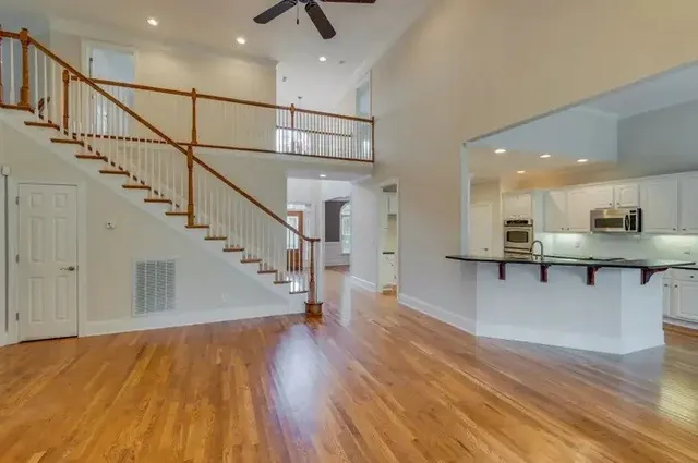 a view of kitchen with wooden floor and electronic appliances