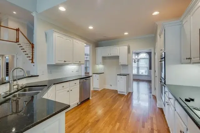 a kitchen with stainless steel appliances a sink stove and refrigerator