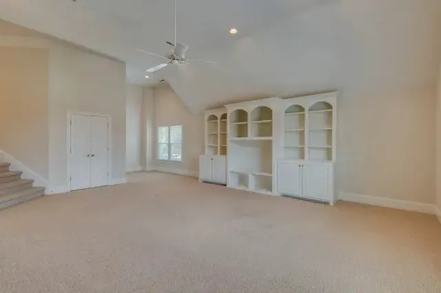 an empty room with a empty space and windows