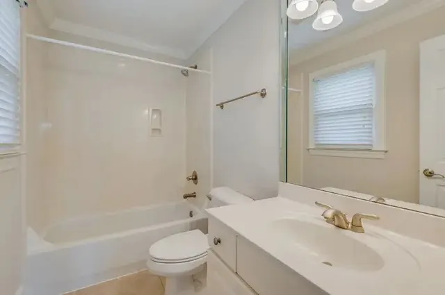 a bathroom with a sink vanity granite shower and a mirror