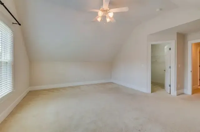 an empty room with windows and air conditioner