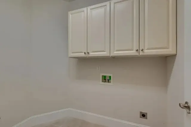 a living room with couch and a floor to ceiling window