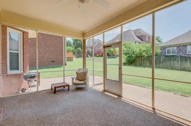 a view of a house with a backyard and a patio