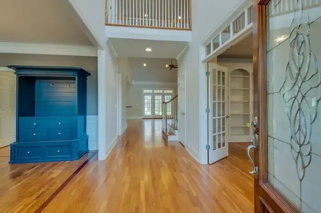 a view of a hallway with wooden floor