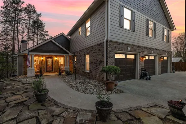 a view of a house with backyard and sitting area