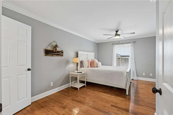 a bedroom with a bed couch and a large window
