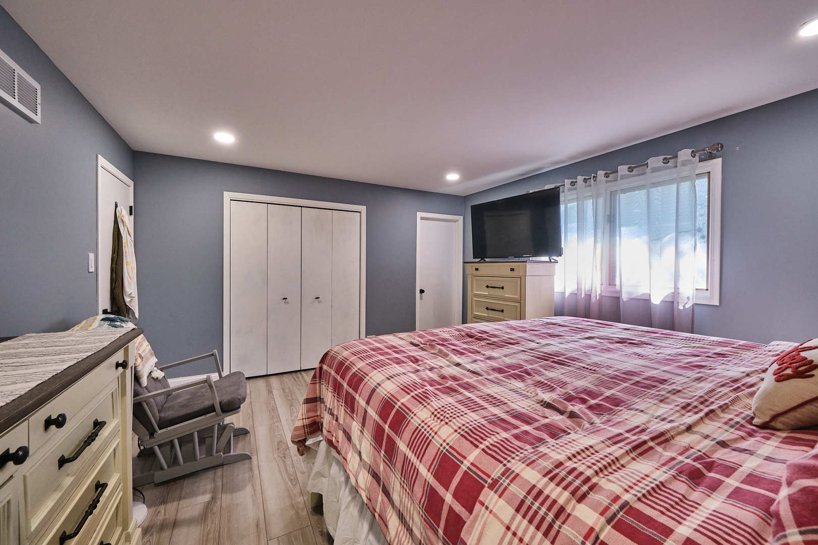 1115 Birch Road Homewood, IL 60430 - Photo 28 of 47 a spacious bedroom with a bed and a flat screen tv