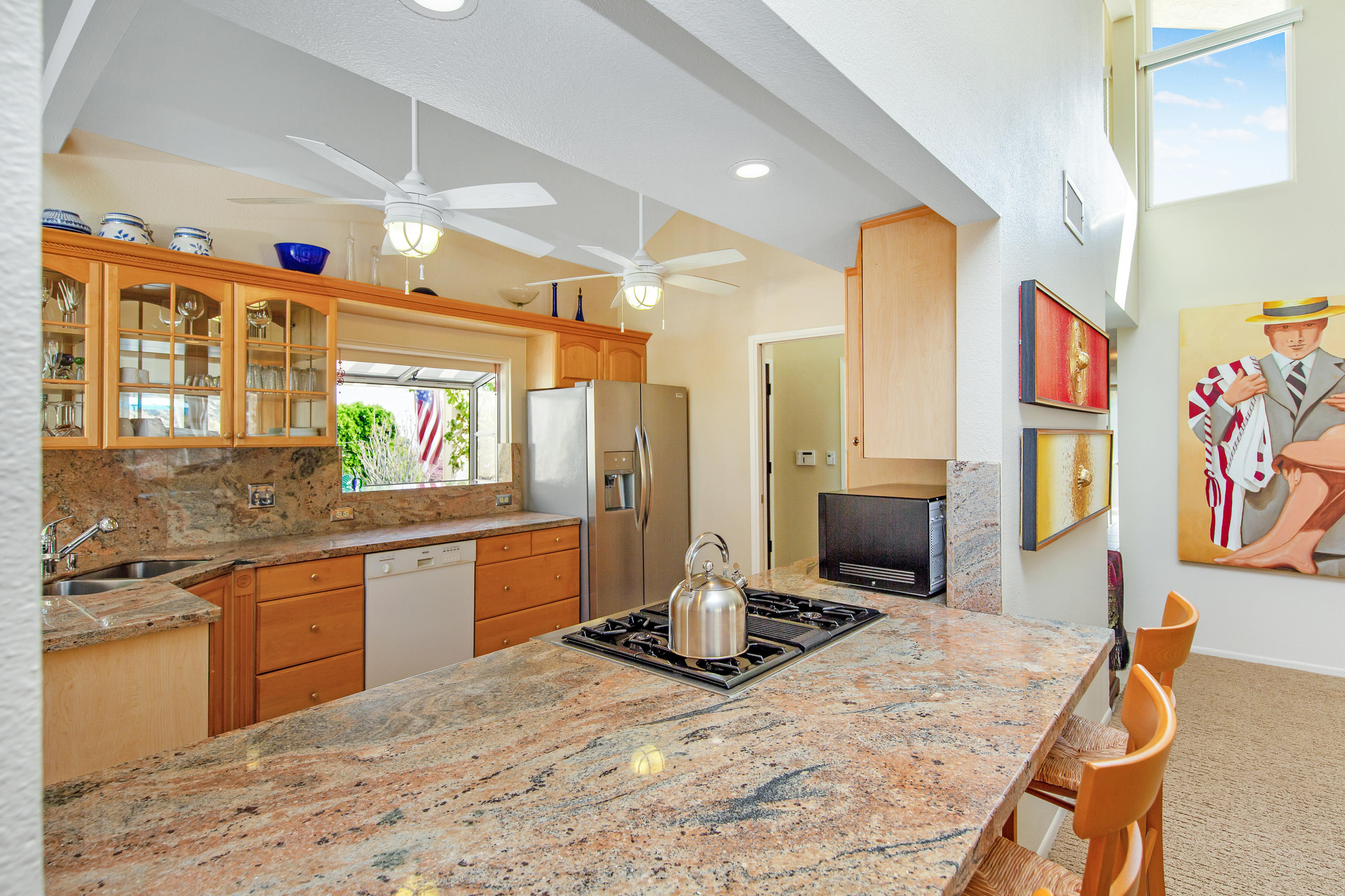 67825 Foothill Road Cathedral City, CA 92234 - Photo 14 of 48 a large kitchen with stainless steel appliances kitchen island granite countertop a sink and cabinets