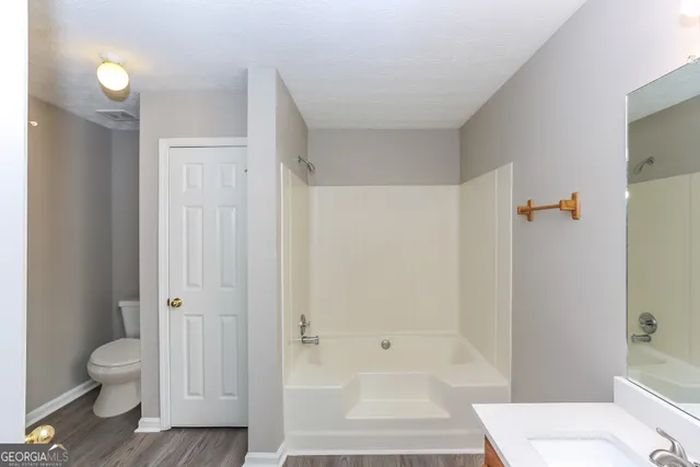 a bathroom with a shower and a toilet