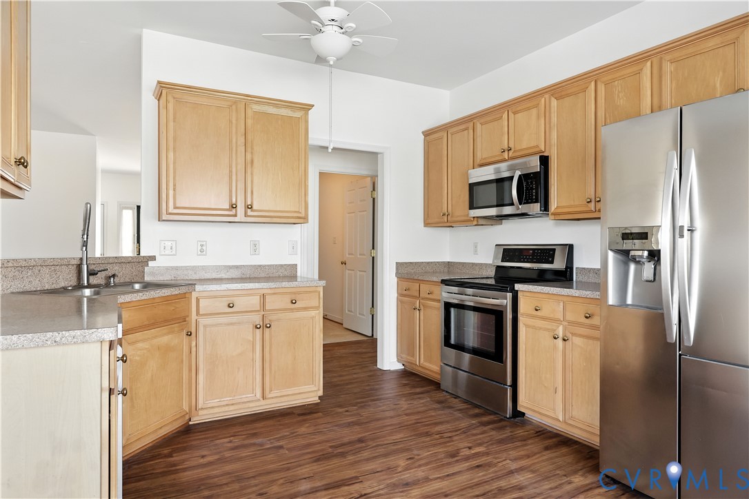 695 Krim Point Loop Midlothian, VA 23114 - Photo 15 of 29 Kitchen with stainless steel appliances, light bro