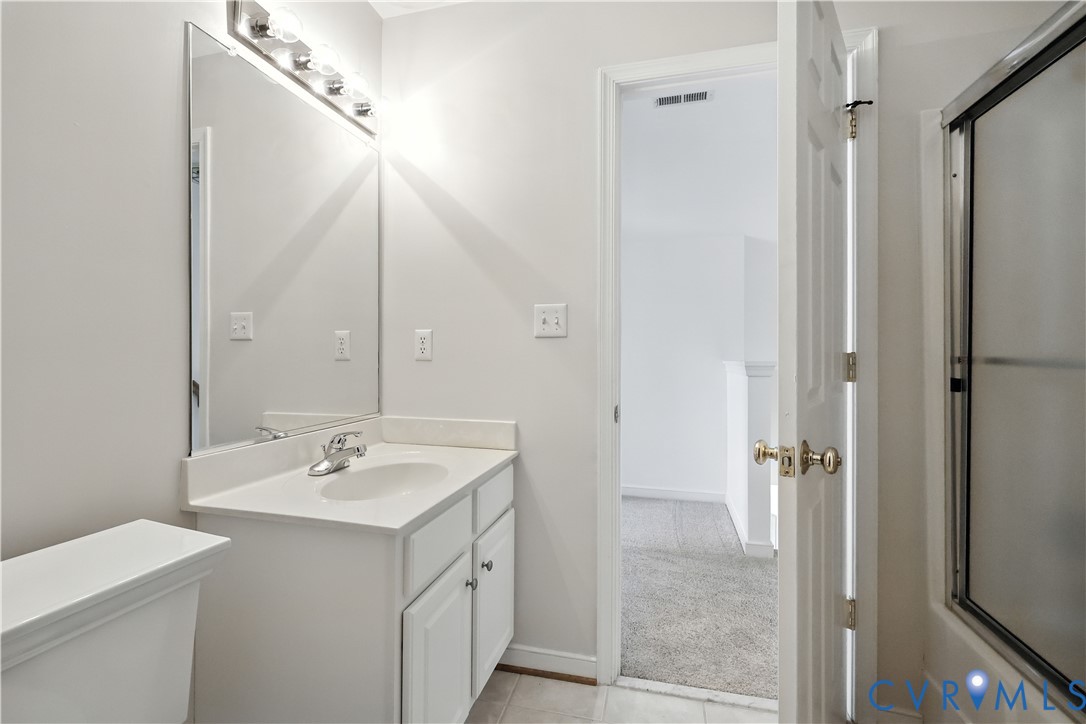 695 Krim Point Loop Midlothian, VA 23114 - Photo 25 of 29 Bathroom featuring vanity and light tile patterned