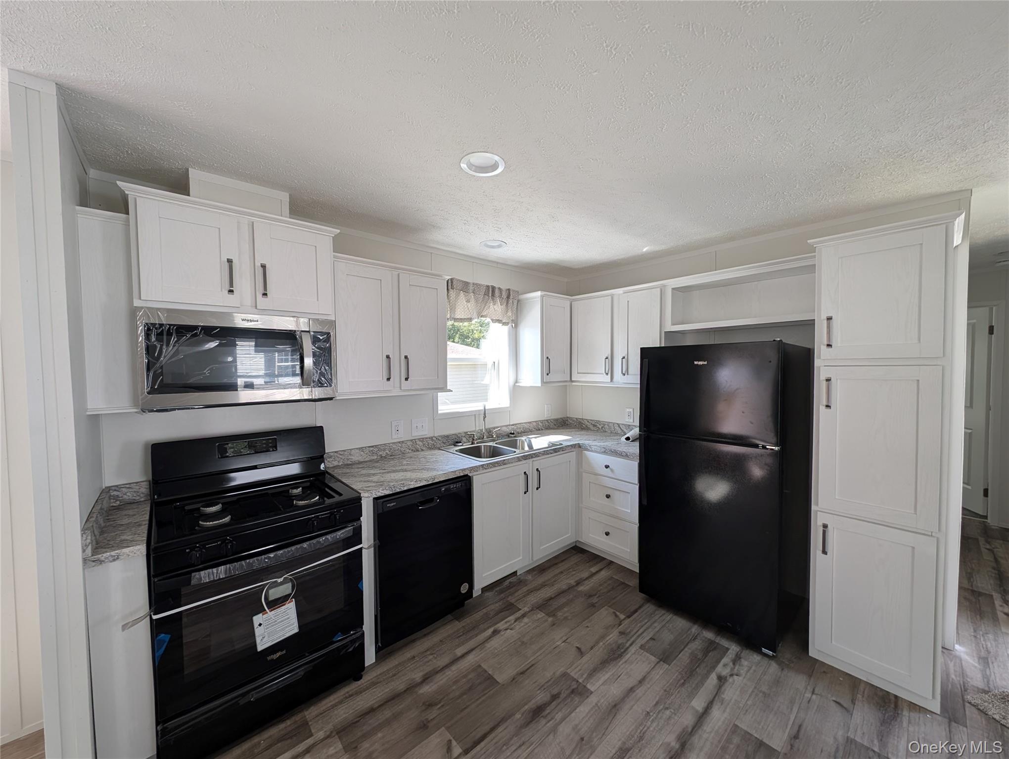 3146 Rte 9W, Unit 8A New Windsor, NY 12553 - Photo 3 of 14 a kitchen with a refrigerator and a stove top oven