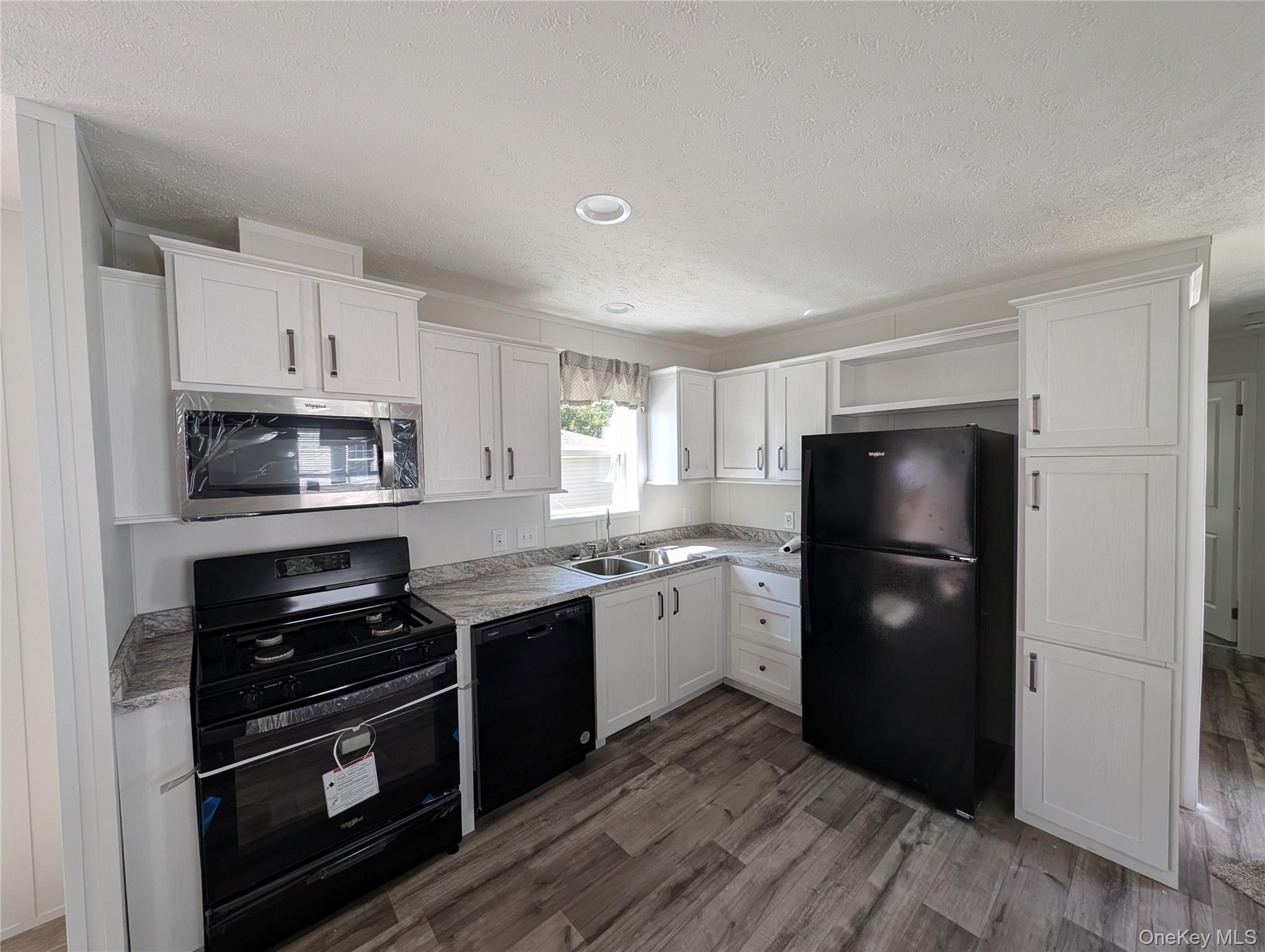 3146 Rte 9W, Unit 8A New Windsor, NY 12553 - Photo 4 of 14 a kitchen with a refrigerator and a stove top oven