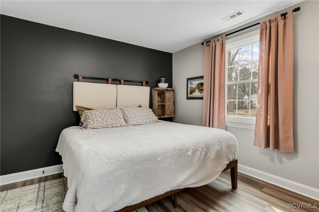206 West McClellan Street Sandston, VA 23150 - Photo 17 of 24 a large bed sitting in a bedroom next to a window