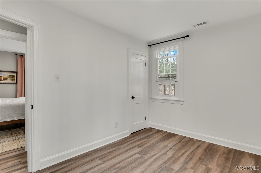206 West McClellan Street Sandston, VA 23150 - Photo 19 of 24 a view of an empty room with wooden floor and a window