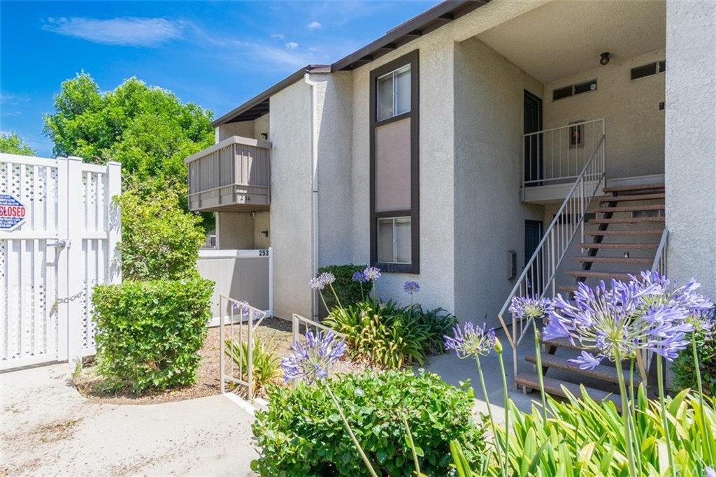 8990 19th Street, Unit 254 Rancho Cucamonga, CA 91701 - Photo 1 of 1 a front view of a house with a yard and fountain