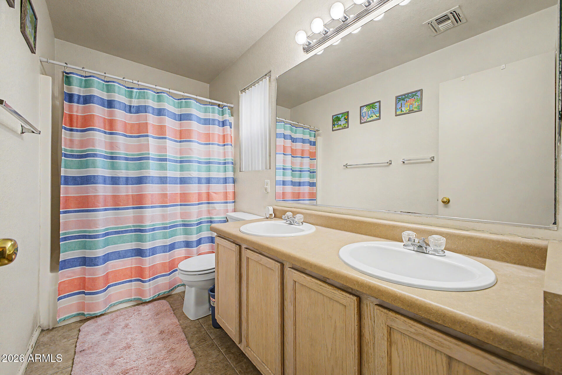 2607 West Bloch Road Phoenix, AZ 85041 - Photo 24 of 34 a bathroom with a sink and a mirror