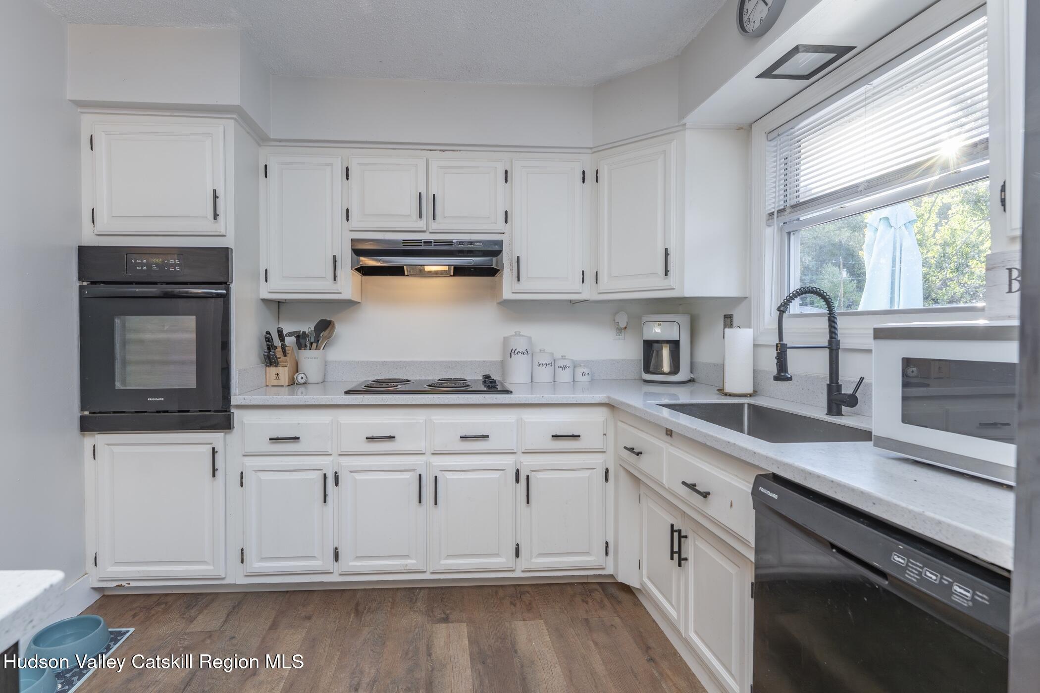 30 Willow Road Saugerties, NY 12477 - Photo 16 of 40 a kitchen with granite countertop white cabinets and white appliances