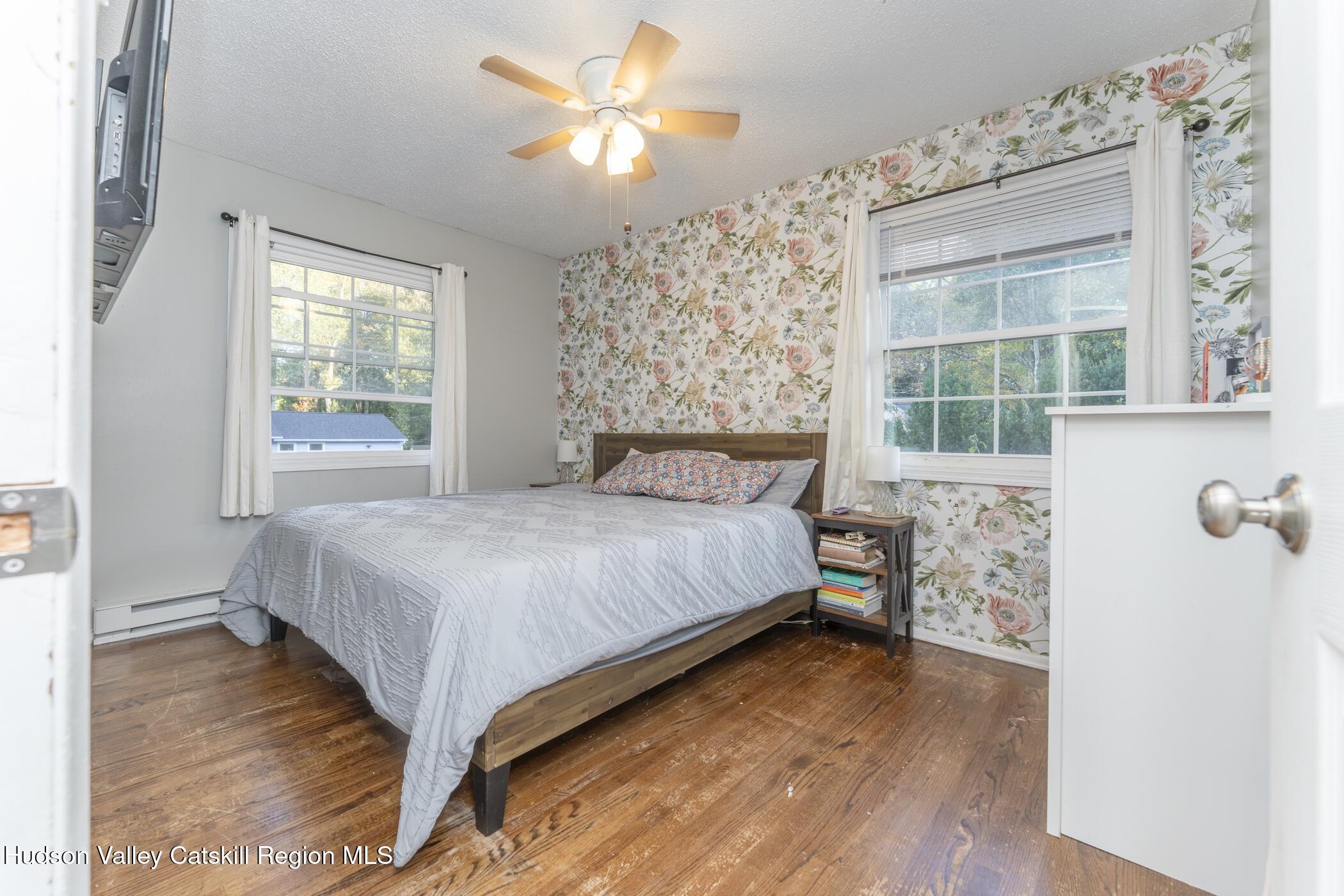 30 Willow Road Saugerties, NY 12477 - Photo 17 of 40 a bedroom with a large bed and a chandelier