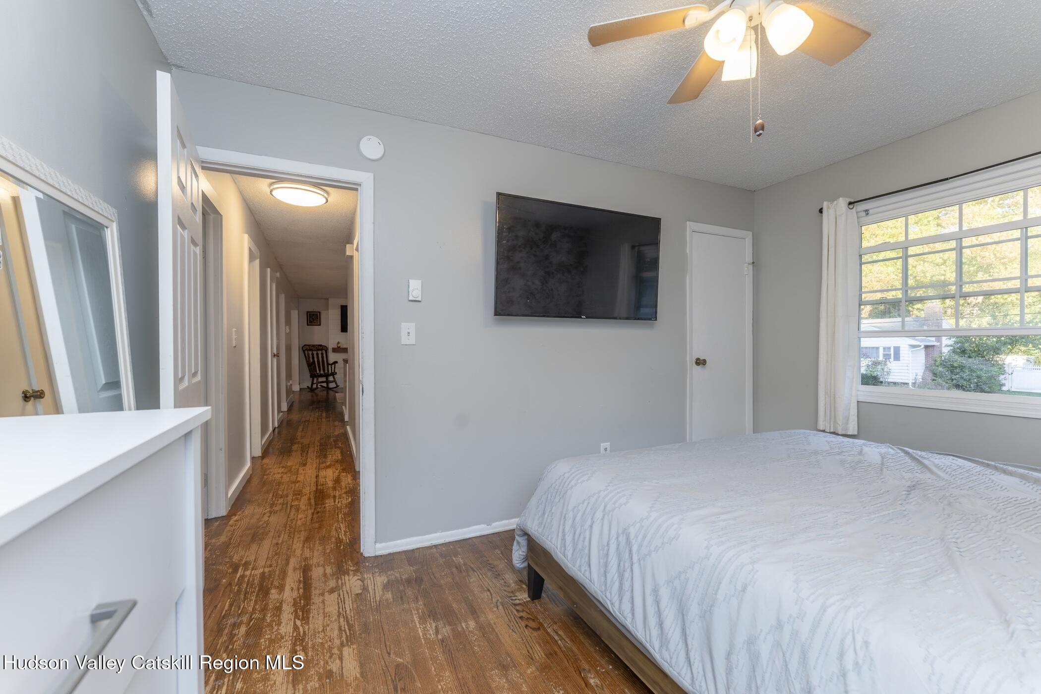 30 Willow Road Saugerties, NY 12477 - Photo 18 of 40 a bedroom with a bed and a flat tv screen next to a window