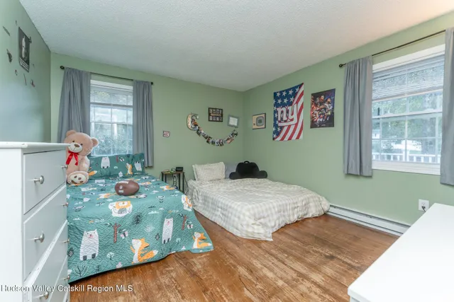 a bedroom with two beds and a window