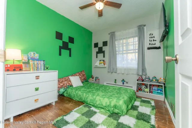 a bedroom with a bed and a chandelier fan