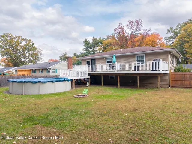 a view of a house with pool and a yard
