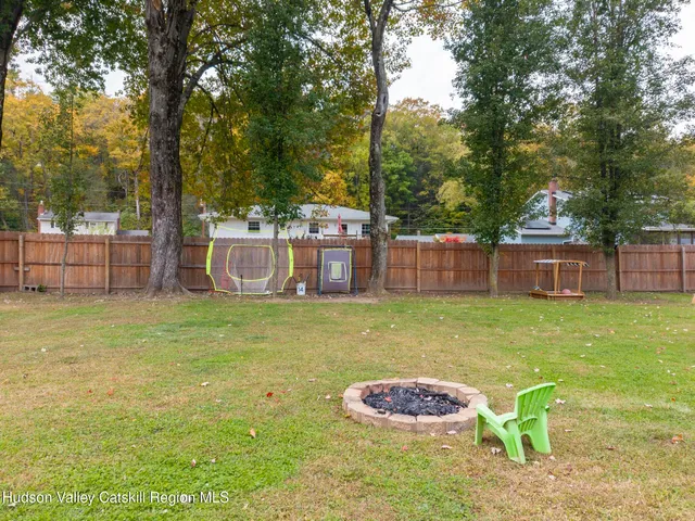 a backyard of a house with table and chairs