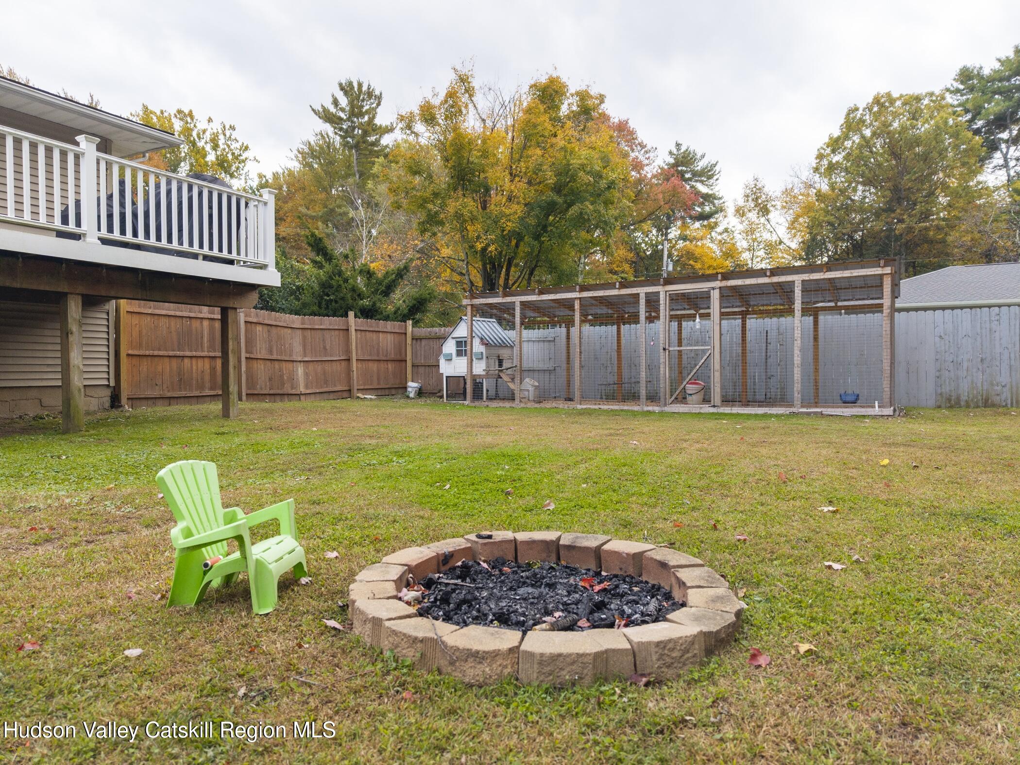 30 Willow Road Saugerties, NY 12477 - Photo 37 of 40 a view of a backyard with table and chairs and wooden fence