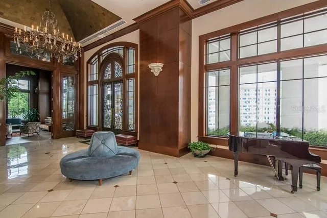 a living room with furniture and large windows